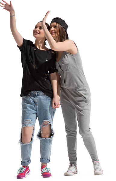 Two standing girlfriends waving image