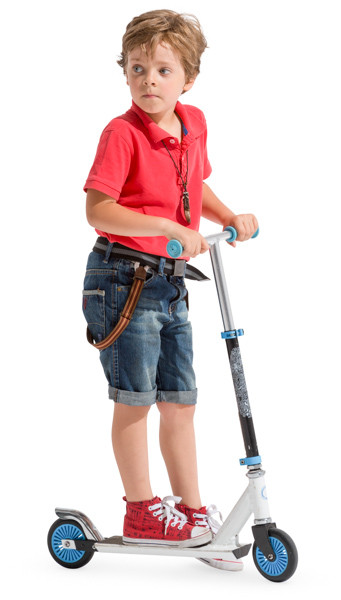 Young boy on scooter image