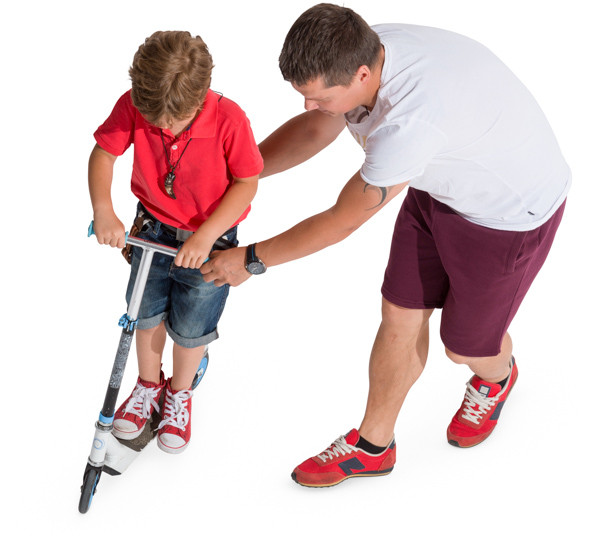 Father helping son riding image
