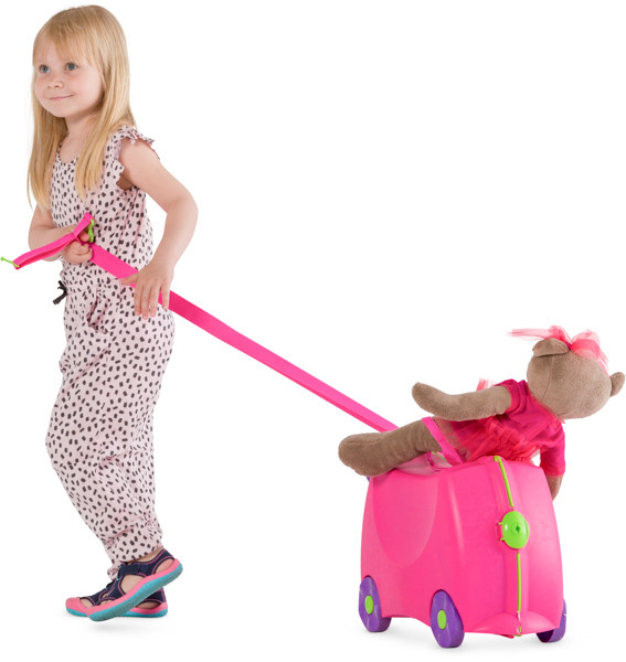 Girl is pulling a toy suitcase image