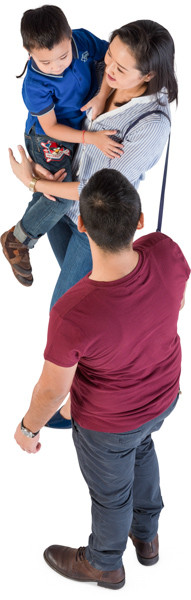 Standing mother and father with son on hands image