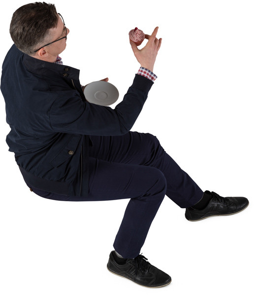 Sitting man eating a cake image