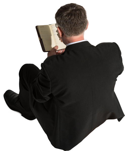 Sitting man with notepad image