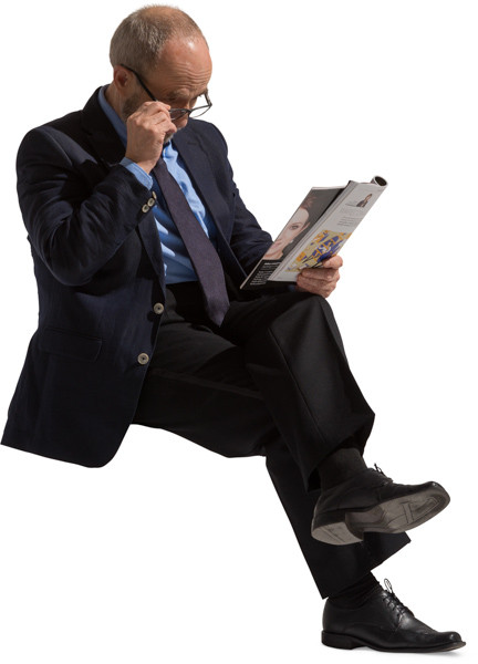 Sitting man with a newspaper image
