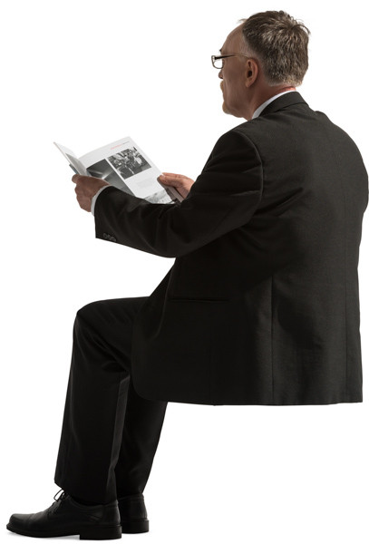 Sitting man reading a newspaper image