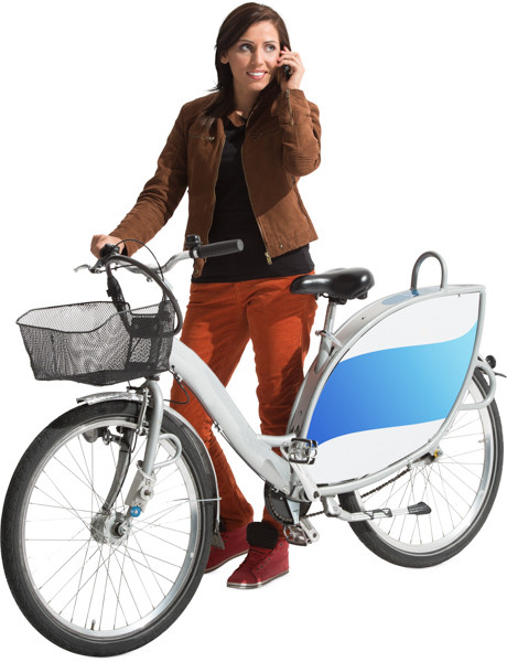 Woman standing next to bike image