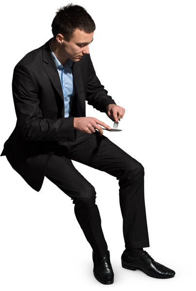 Sitting man eating meal image