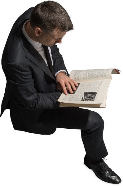 Sitting man with a magazine image