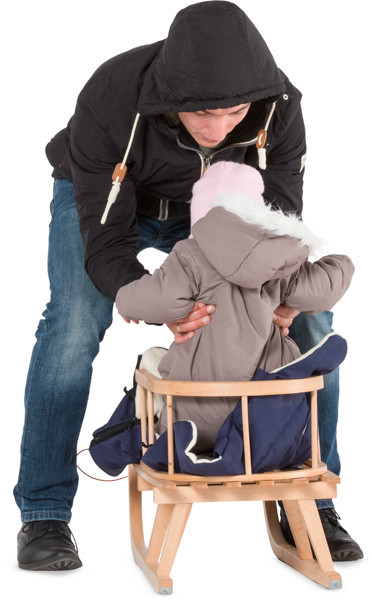 Father with child on sledge image