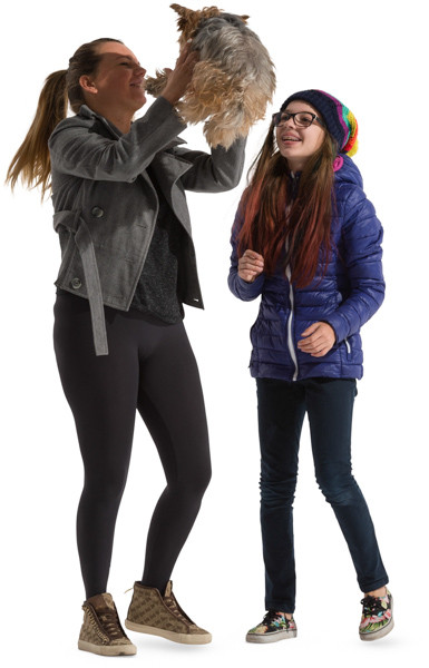 Mother and daughter playing with pet image