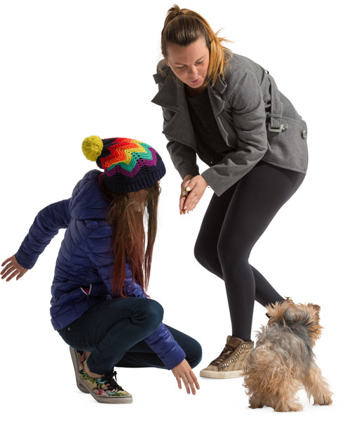 Mother and daughter playing with pet image
