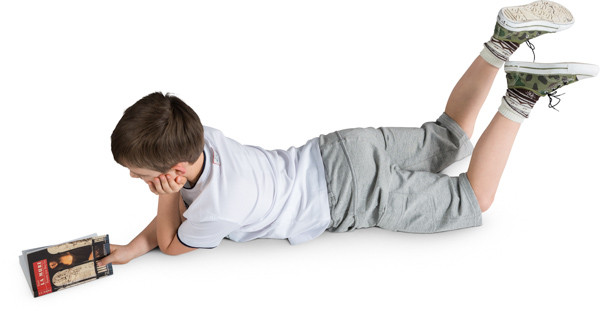 Boy lying with a book image