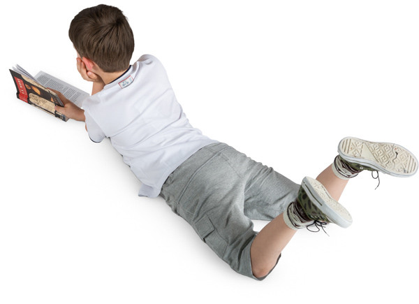 Boy lying with a book image