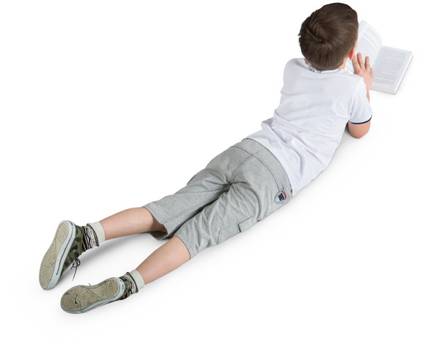 Boy lying with a book image