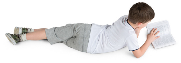 Boy lying with a book image