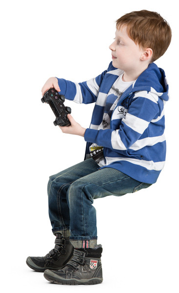Sitting boy playing video game image