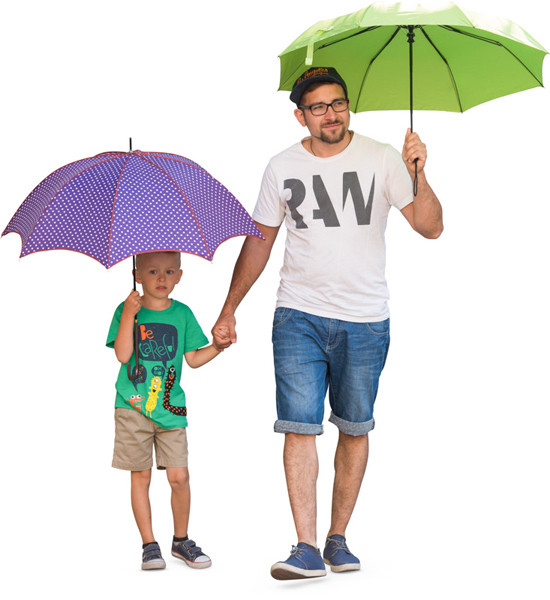 Father and son walking with umbrellas image