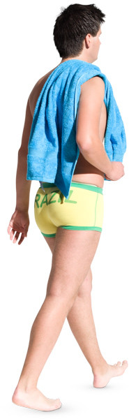 Man walking in yellow shorts and holding towel image