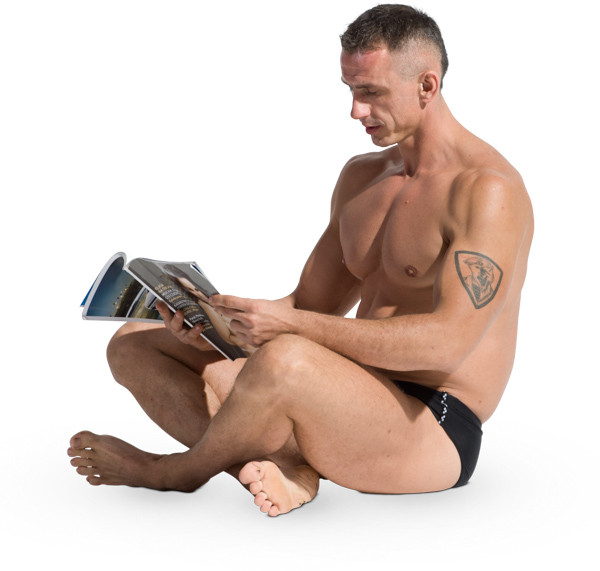 Sitting man looking to magazine image