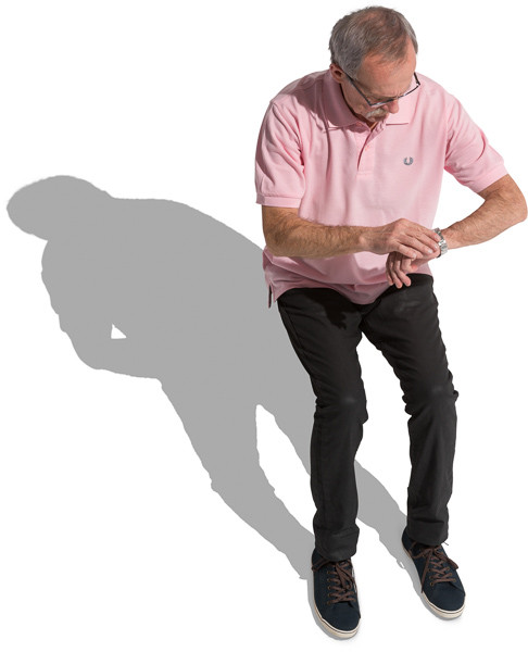 Man in polo shirt sitting and checking the watch image