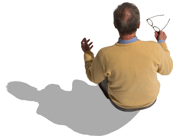 Sitting man holds glasses in hands image