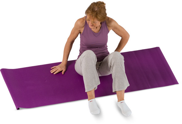 Mature woman training on yoga mate image